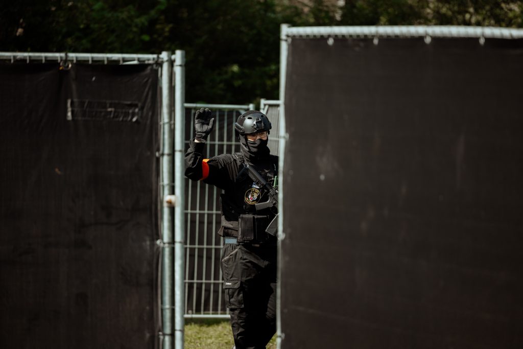 Airsofter tussen twee schotten in op een buiten skirm locatie